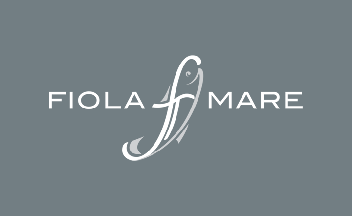fiola mare logo with a fish symbol in the center made up of the letters F T which stand for chef Fabio Trabocchi